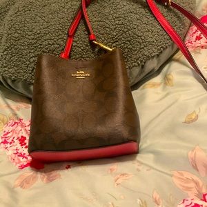 Crossgrain leather Inside open pocket zip top closure Detachable strap